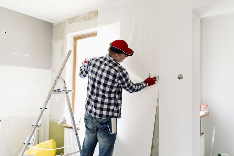 Expert preparing walls for wallpaper